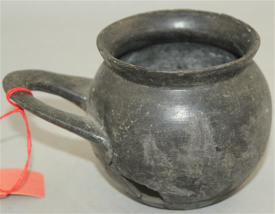 An Etruscan Bucchero ware single handled cup, c. 6th century BC, 9cm, repaired